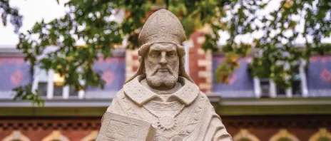 A stone statue of Saint Ambrose of Milan outside.